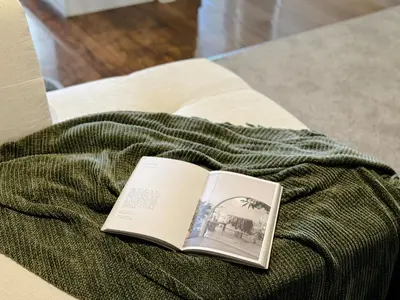 a book sitting on top of a green blanket at Stylish 1 Bedroom Apartment in LA with Free Parking - 10 Minutes away from Ceders Sinai in Los Angeles