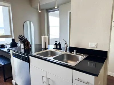 a kitchen counter with a sink and a mirror at Stylish 1 Bedroom Apartment in LA with Free Parking - 10 Minutes away from Ceders Sinai in Los Angeles