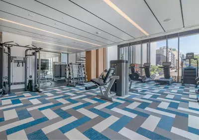 a gym with treadmills and machines in a building at Cosmopolitan Hollywood Home DTLA view Parking - 10mins to Universal Studios in Los Angeles