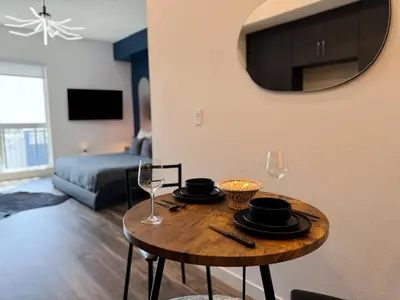 a living room with a table with plates and wine glasses at Cosmopolitan Hollywood Home DTLA view Parking - 10mins to Universal Studios in Los Angeles