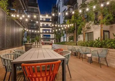 a table and chairs on a patio with lights at Modern Hollywood Home Sunset View & Free Parking - 10mins to Universal Studios in Los Angeles