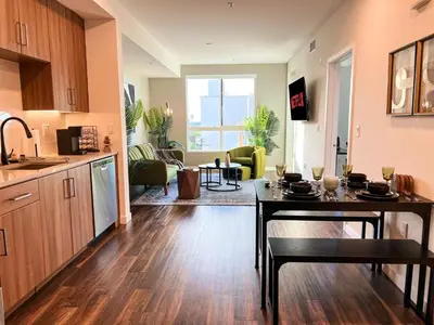 a kitchen and living room with a table in a kitchen at Luxurious Hollywood Home City View - Free Parking 10mins to Universal Studios in Los Angeles