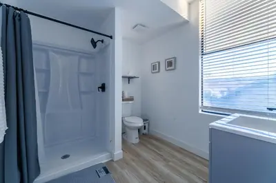 a bathroom with a shower and a toilet and a sink at Quiet King bed Westward Room in heart of Pasadena in Pasadena