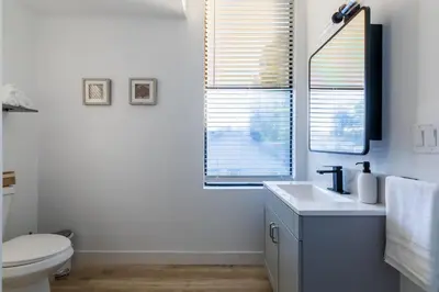 a bathroom with a sink and a toilet and a mirror at Quiet King bed Westward Room in heart of Pasadena in Pasadena