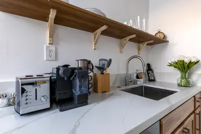 a kitchen counter with a coffee maker and a sink at Quiet King bed Westward Room in heart of Pasadena in Pasadena