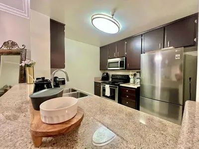 a large kitchen with a stainless steel refrigerator at Shared House Hollywood Hideaway Heart of Fame in Los Angeles