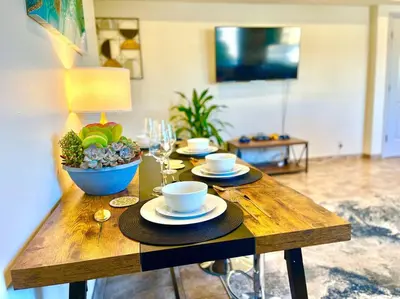 a wooden table with two cups and a bowl of food at FuLLy LoAdeD ReSerVaTioN 3bed 2ba w Parking in Los Angeles