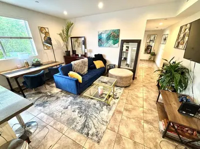 a living room with a blue couch and a table at FuLLy LoAdeD ReSerVaTioN 3bed 2ba w Parking in Los Angeles