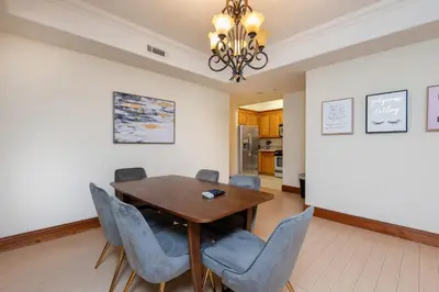 a dining room with a wooden table and blue chairs at Luxurious Apt Your Private Gem in LA in Los Angeles
