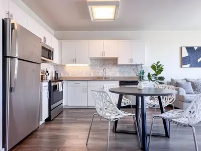 a kitchen with white cabinets and a table and chairs at Monthier Downtown SA5S1U0 in Los Angeles