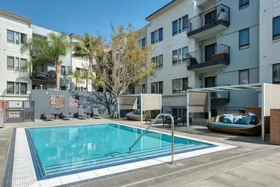 a swimming pool in front of a apartment building at Monthier LACMA WI4S4U0 in Los Angeles