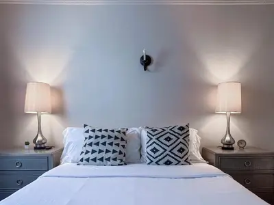 a bedroom with a white bed with two lamps at Monthier Picfair Village CA1H6O23 in Los Angeles