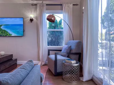a living room with a blue couch and a window at Monthier Picfair Village CA1H6O23 in Los Angeles