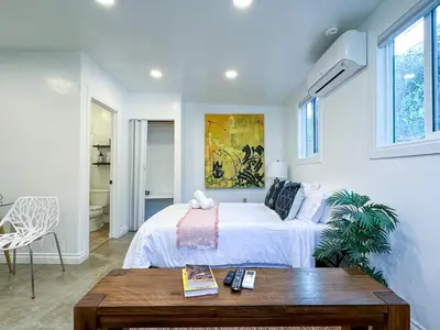 a white bedroom with a bed and a table at Monthier Picfair Village CA1G6H23 in Los Angeles