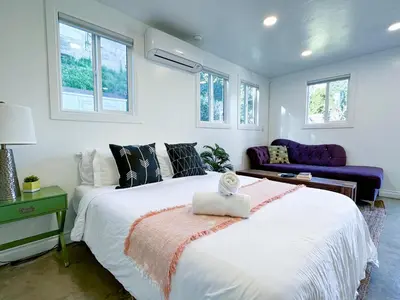 a bedroom with a large white bed and windows at Monthier Picfair Village CA1G6H23 in Los Angeles