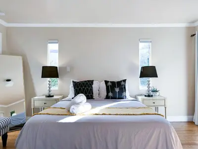 a bedroom with a large bed with two night stands at Monthier Picfair Village CA1G6R23 in Los Angeles