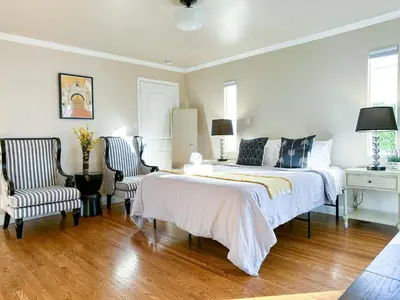 a bedroom with a large bed and two chairs at Monthier Picfair Village CA1G6R23 in Los Angeles