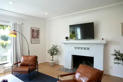 a living room with a fireplace with a tv above it at Monthier The Grove OA7T4H55 in Los Angeles