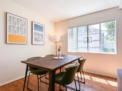 a dining room with a wooden table and green chairs at Monthier LACMA SI5T8H57 in Los Angeles