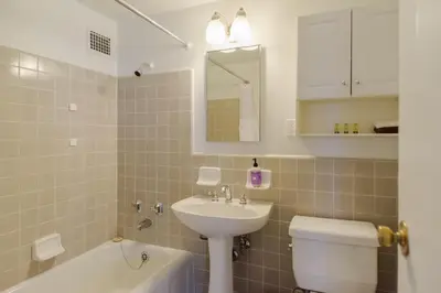 a bathroom with a sink and a toilet and a bath tub at Los Angeles Townhouse close to LACMA in Los Angeles