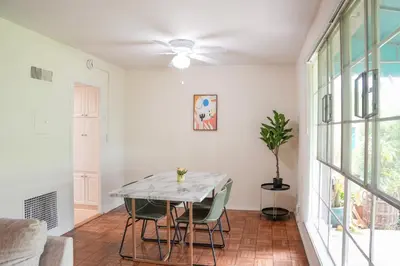 a dining room with a table and chairs at Los Angeles Townhouse close to LACMA in Los Angeles