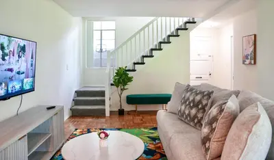 a living room with a couch and a table at Los Angeles Townhouse close to LACMA in Los Angeles