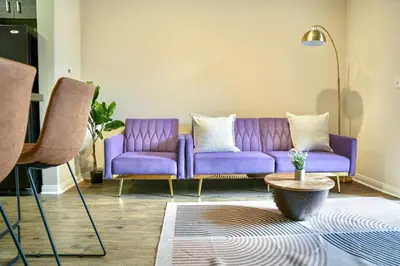 a purple couch in a living room with a table at Los Angeles Suite LACMA in Los Angeles