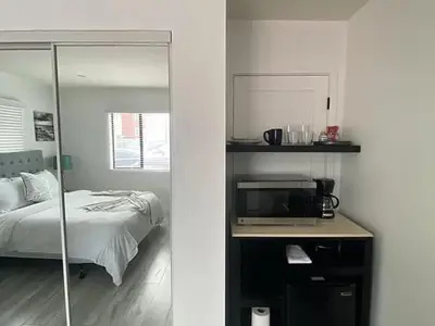 a bedroom with a bed and a microwave on a desk at Sunny Studio in the Heart of Venice - A in Los Angeles
