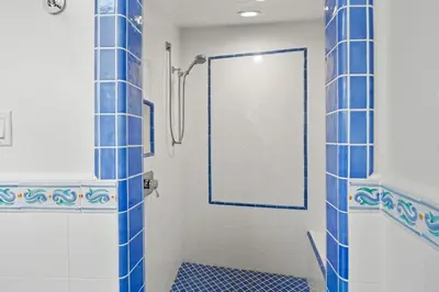 a bathroom with a shower with a glass door at Sand Side Bliss in Oxnard