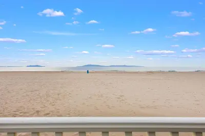 a view of the beach from a fence at Sand Side Bliss in Oxnard