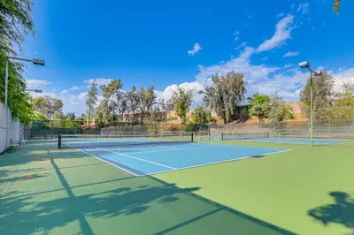 a tennis court with two tennis courts at Redlands Home with Community Perks 1 Mi to Downtown in Redlands
