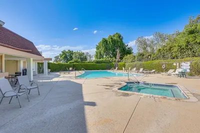 a backyard with a swimming pool and chairs and a house at Redlands Home with Community Perks 1 Mi to Downtown in Redlands