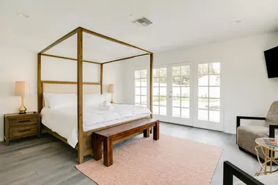 a bedroom with a canopy bed with a table and a couch at Monthier Melrose PO7H2O0 in Los Angeles
