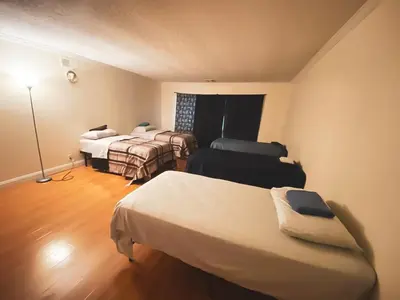 a hotel room with two beds and a lamp at House Downtown OC Santa Ana in Santa Ana
