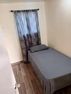 a small room with two beds and a window at House Downtown OC Santa Ana in Santa Ana