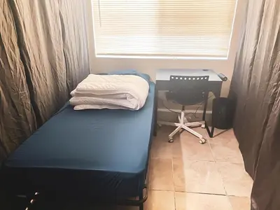 a room with a bed and a desk and a chair at House Downtown OC Santa Ana in Santa Ana