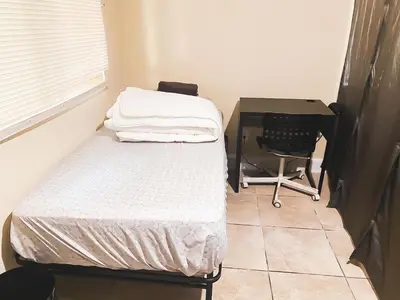 a bedroom with a bed and a desk and a computer at House Downtown OC Santa Ana in Santa Ana