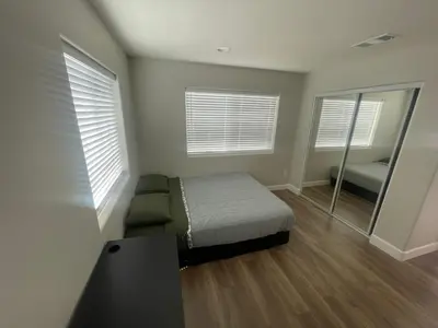 a bedroom with a bed and a mirror at House Downtown OC Santa Ana in Santa Ana