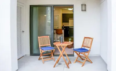 two chairs and a table on a porch at Los Angeles Modern Studio in Los Angeles