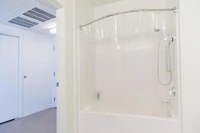 a shower in a white bathroom with a glass wall at Suite Little Tokyo Los Angeles in Los Angeles