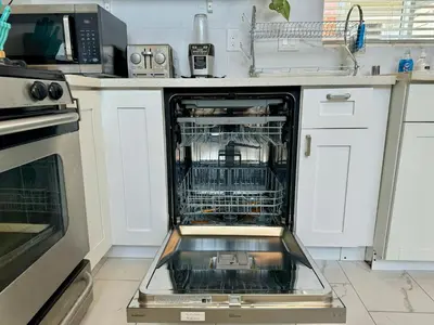 a dishwasher with its dishes inside of it in a kitchen at Brand-New Dtla building with rooftop patio in Alhambra