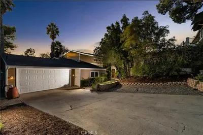 a house with a white garage and a driveway at Panorama Tropical Resort & Spa with Sunset City View in Santa Ana
