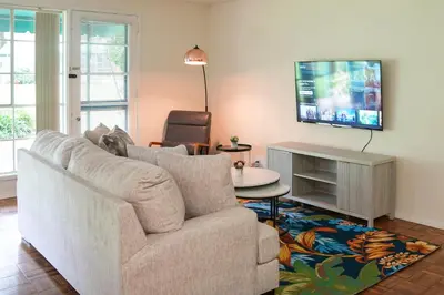 a living room with a couch and a tv at Los Angeles Miracle Mile Spacious 2BR Townhouse in Los Angeles