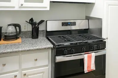 a kitchen with a black stove top oven at Los Angeles Miracle Mile Spacious 2BR Townhouse in Los Angeles