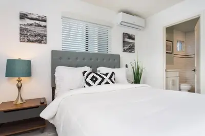 a white bedroom with a large bed with white pillows at Sunny 1 Bedroom in the Heart of Venice Beach - 2 in Los Angeles