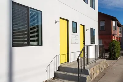a building with yellow doors and stairs on a street at Sunny 1 Bedroom in the Heart of Venice Beach - 2 in Los Angeles