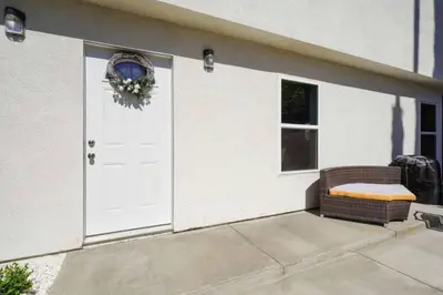 a white house with a white door and a wreath at Spacious family Guesthouse private entry near six flags in Santa Clarita