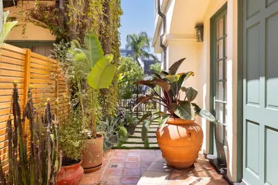 a patio with a bunch of potted plants and a door at The Canal Escape - canal-front Italian villa in Los Angeles