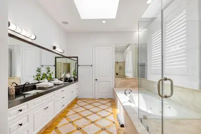 a large bathroom with a tub and a sink at The Canal Escape - canal-front Italian villa in Los Angeles