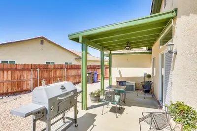 a patio with a grill and a table and chairs at Victorville Home with Large Yard and Charcoal Grill! in Victorville